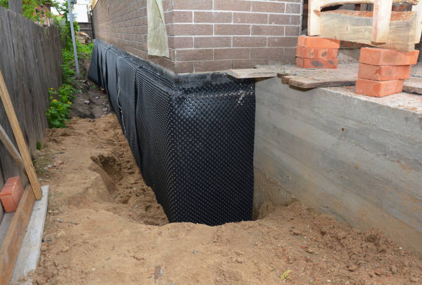 Happy homeowners after waterproofing job in Delton